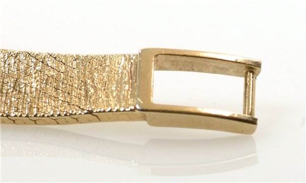 This image shows a close-up of the buckle from a gold bracelet of the Rolex Cocktail 8370 Women's Yellow Gold Champagne Dial 8370 Women's Yellow Gold Champagne Dial model watch.