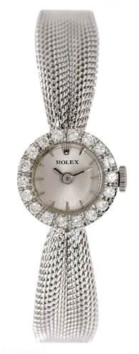 This image shows a Rolex Cocktail Women's White Gold Silver Dial Women's White Gold Silver Dial watch from a top-down angle, emphasizing its diamond-encrusted bezel and mesh bracelet.