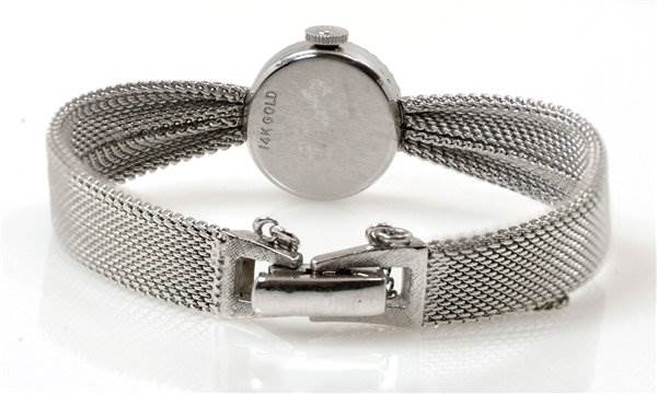 The image shows the back of a Rolex Cocktail Women's White Gold Silver Dial Women's White Gold Silver Dial watch, displaying its clasp and mesh band.