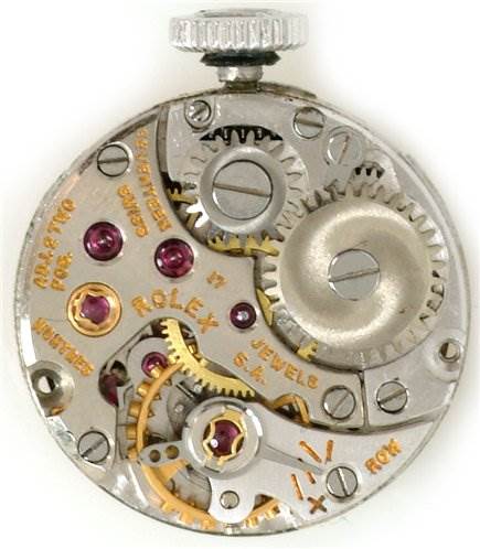 This image shows a detailed view of the internal mechanism of a Rolex Cocktail Women's White Gold Silver Dial Women's White Gold Silver Dial model watch, highlighting gears and jewels.