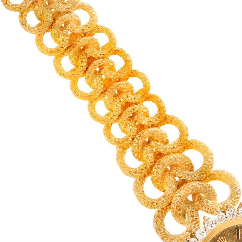 The image shows a close-up view of the gold band of the Rolex Cocktail 8312 Women's Yellow Gold Champagne Dial 8312 Women's Yellow Gold Champagne Dial model watch, with part of the watch face visible.