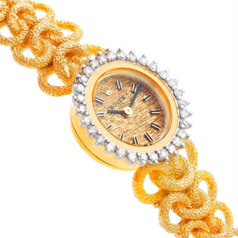 This is the face and part of the bracelet of a Rolex Cocktail 8312 Women's Yellow Gold Champagne Dial 8312 Women's Yellow Gold Champagne Dial watch, highlighting its gold dial and diamond-encrusted bezel.