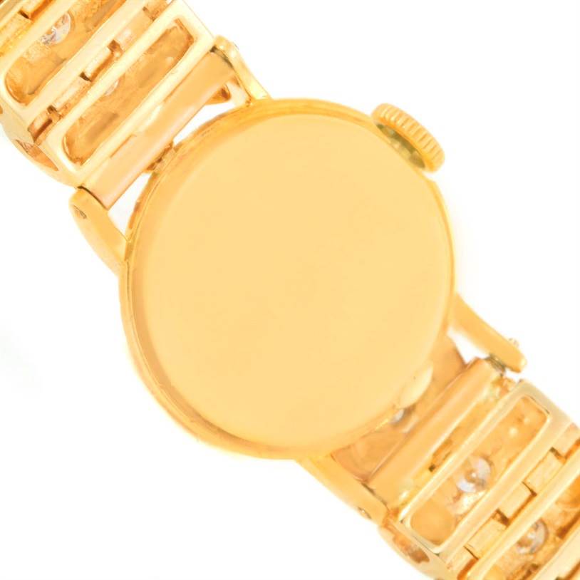 The image shows the back of the Rolex Cocktail 8271 Women's Yellow Gold Silver Dial 8271 Women's Yellow Gold Silver Dial model watch, including parts of its golden strap.