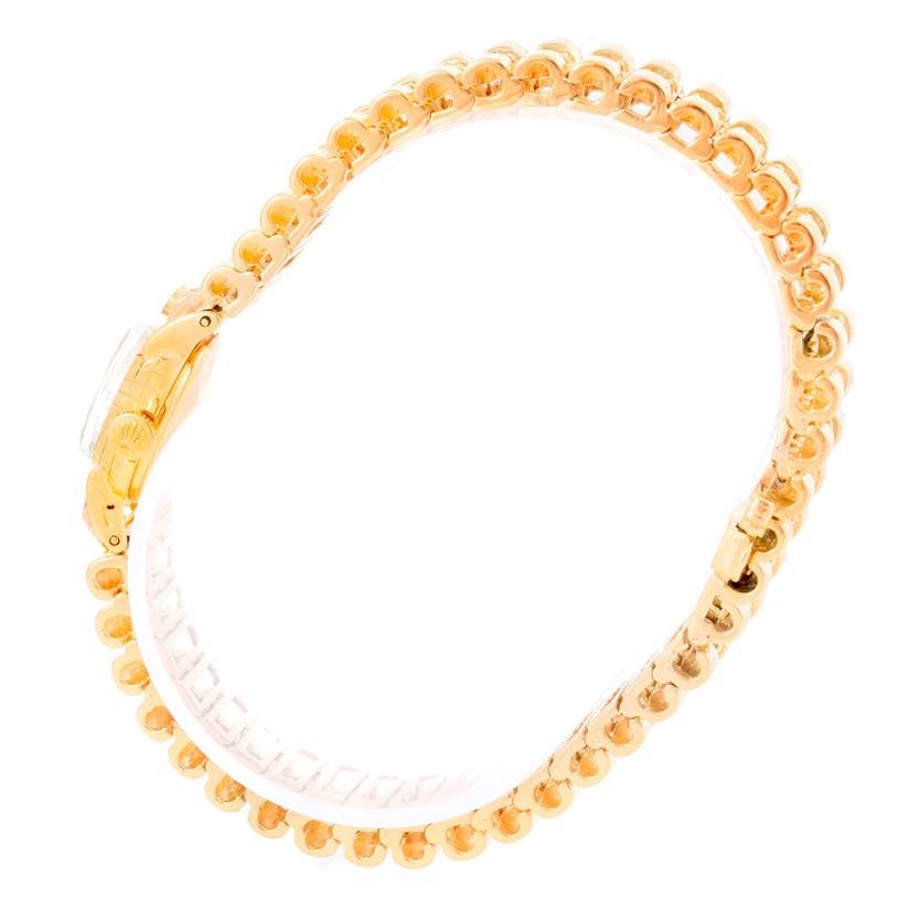 This is a side view of the Rolex Cocktail 8271 Women's Yellow Gold Silver Dial 8271 Women's Yellow Gold Silver Dial model watch, showcasing its gold bracelet and clasp.