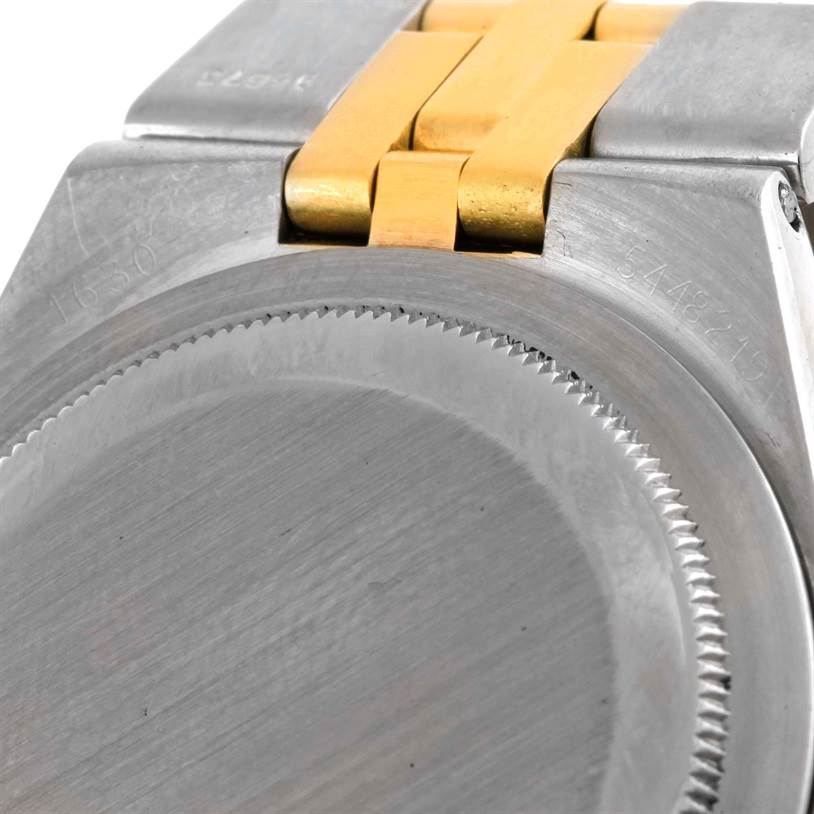 The image shows the back case and part of the bracelet of a Vintage Collection Rolex watch.