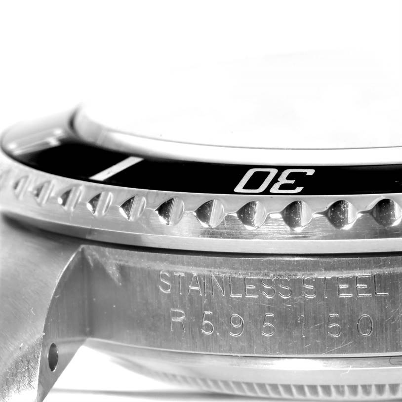 The image shows a close-up of the case and bezel of a Vintage Collection model watch by Rolex.