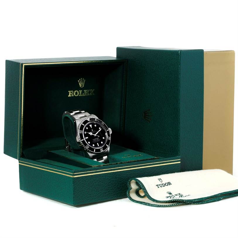 The Rolex Vintage Collection 168000 Men's Stainless Steel Black Dial 168000 Men's Stainless Steel Black Dial watch is shown at an angle inside an open green Rolex box with a white Tudor cloth beside it.