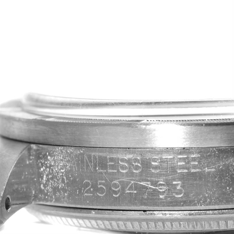 This image shows a close-up side view of the stainless steel case back of a Vintage Collection model by Rolex.