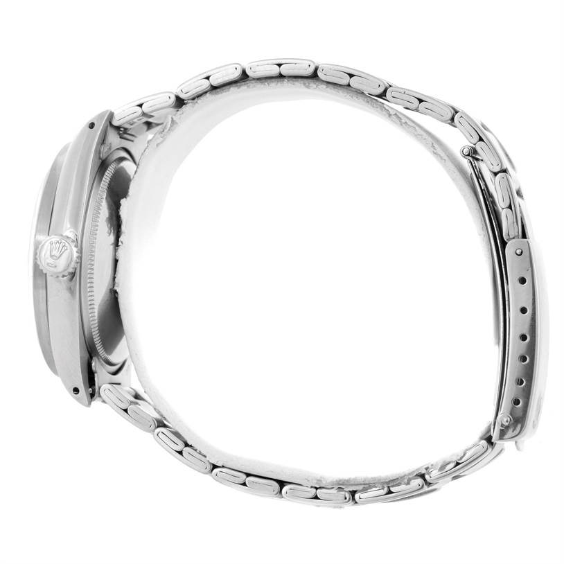 The image shows a side profile of a Rolex Vintage Collection 1501 Men's Stainless Steel Silver Dial 1501 Men's Stainless Steel Silver Dial model watch, highlighting its case, crown, and metal bracelet.