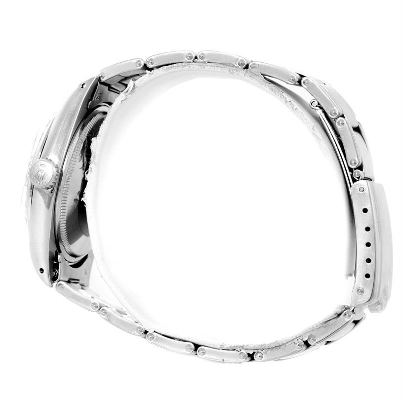 This side view of a Rolex Vintage Collection 1500 Men's Stainless Steel Silver Dial 1500 Men's Stainless Steel Silver Dial watch shows the crown and part of the metal bracelet.