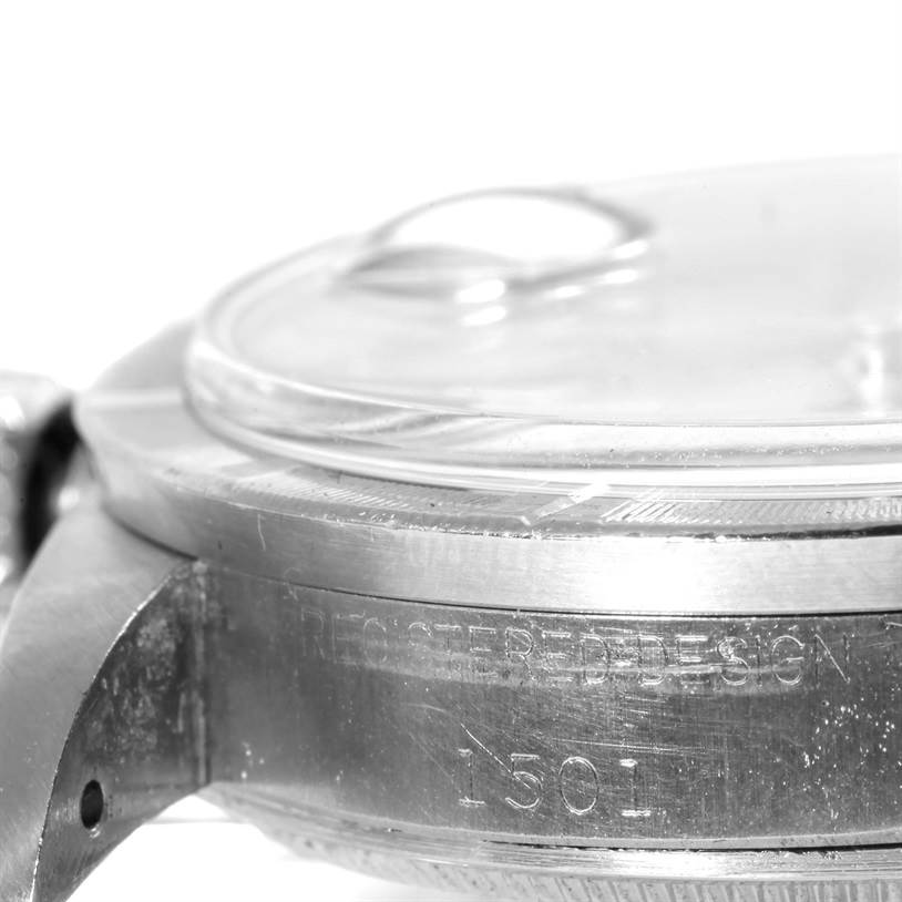 The image shows a close-up angle of the Rolex Vintage Collection 1501 Men's Stainless Steel Silver Dial 1501 Men's Stainless Steel Silver Dial watch's case and crystal, highlighting the "Register Design" engraving and model number.