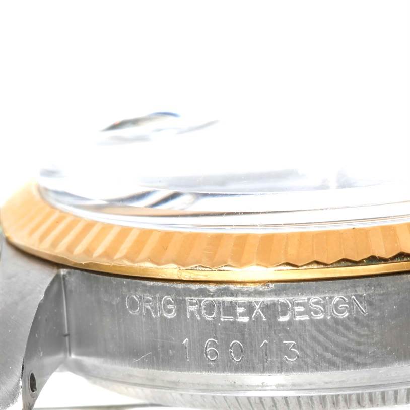 This image shows a close-up side angle of the Rolex Vintage Collection 16013 Men's Stainless Steel Blue Dial 16013 Men's Stainless Steel Blue Dial model, highlighting the bezel, crystal, and case with the model number 16013.