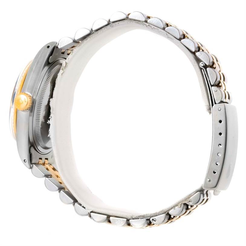 The Vintage Collection Rolex watch is shown from a side angle, highlighting the crown and bracelet.