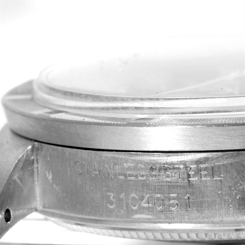 The image shows a close-up of the side of the case and bezel of a Rolex Vintage Collection 1501 Men's Stainless Steel Blue Dial 1501 Men's Stainless Steel Blue Dial watch, highlighting the engraved serial number.