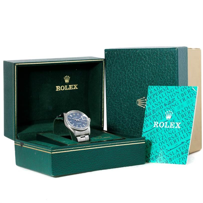 The image shows a Rolex Vintage Collection 1501 Men's Stainless Steel Blue Dial 1501 Men's Stainless Steel Blue Dial watch at a slight angle in an open box with a manual leaning against it.