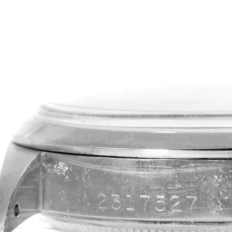 The image shows a close-up of the side case and bezel of a Rolex Vintage Collection 1500 Men's Stainless Steel Silver Dial 1500 Men's Stainless Steel Silver Dial watch with engraved serial numbers.