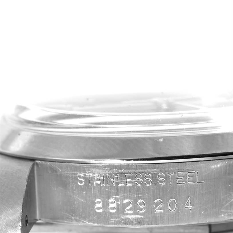 This image shows a close-up side view of the case and bezel of a Rolex Vintage Collection 6694 Men's Stainless Steel Black Dial 6694 Men's Stainless Steel Black Dial watch, displaying "Stainless Steel" and a serial number.