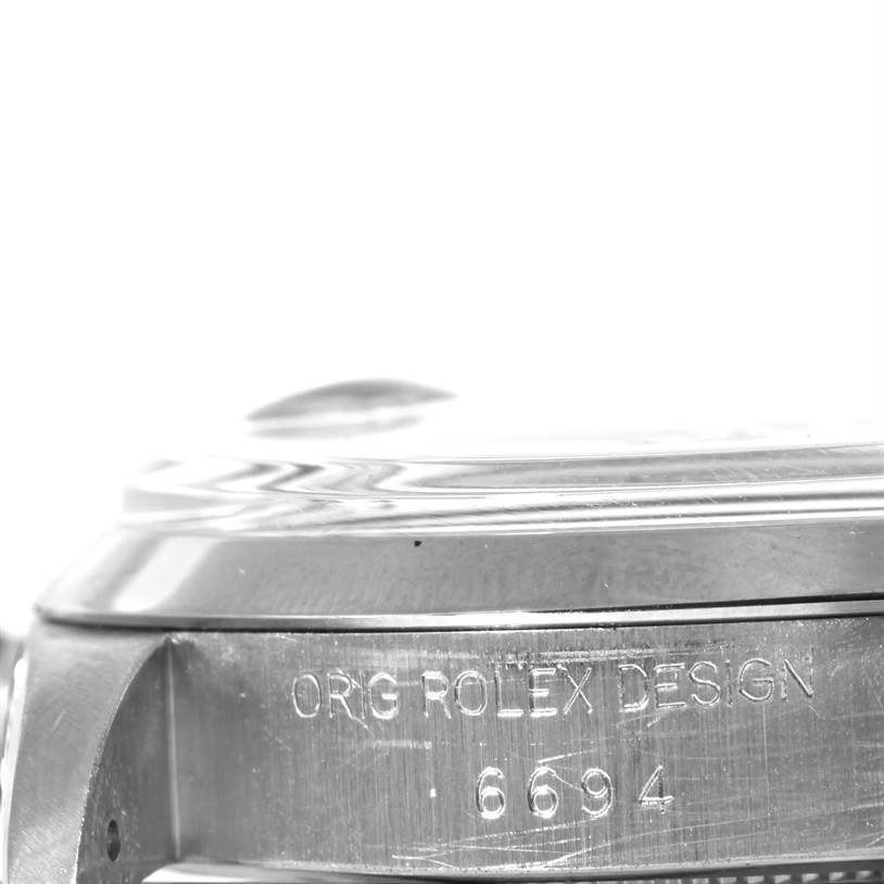 This image shows a close-up side view of the casing of a Vintage Collection Rolex watch, featuring the inscription "ORG ROLEX DESIGN" and the model number "6694".