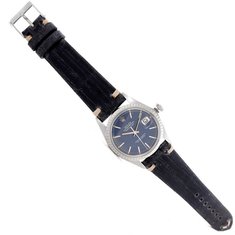 The image displays the full view of a Rolex Vintage Collection 1603 Men's Stainless Steel Blue Dial 1603 Men's Stainless Steel Blue Dial watch, showcasing its face, strap, buckle, and crown from a top-down angle.