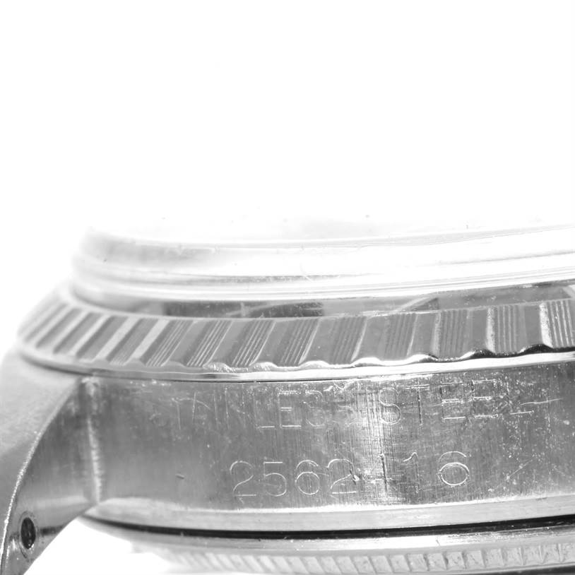 This close-up image of the Rolex Vintage Collection 1603 Men's Stainless Steel Blue Dial 1603 Men's Stainless Steel Blue Dial model shows the side of the watch case, bezel, and serial number engraving.