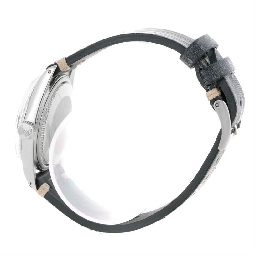 The image shows a side view of the Rolex Vintage Collection 1603 Men's Stainless Steel Blue Dial 1603 Men's Stainless Steel Blue Dial model, highlighting the case, crown, and leather strap.