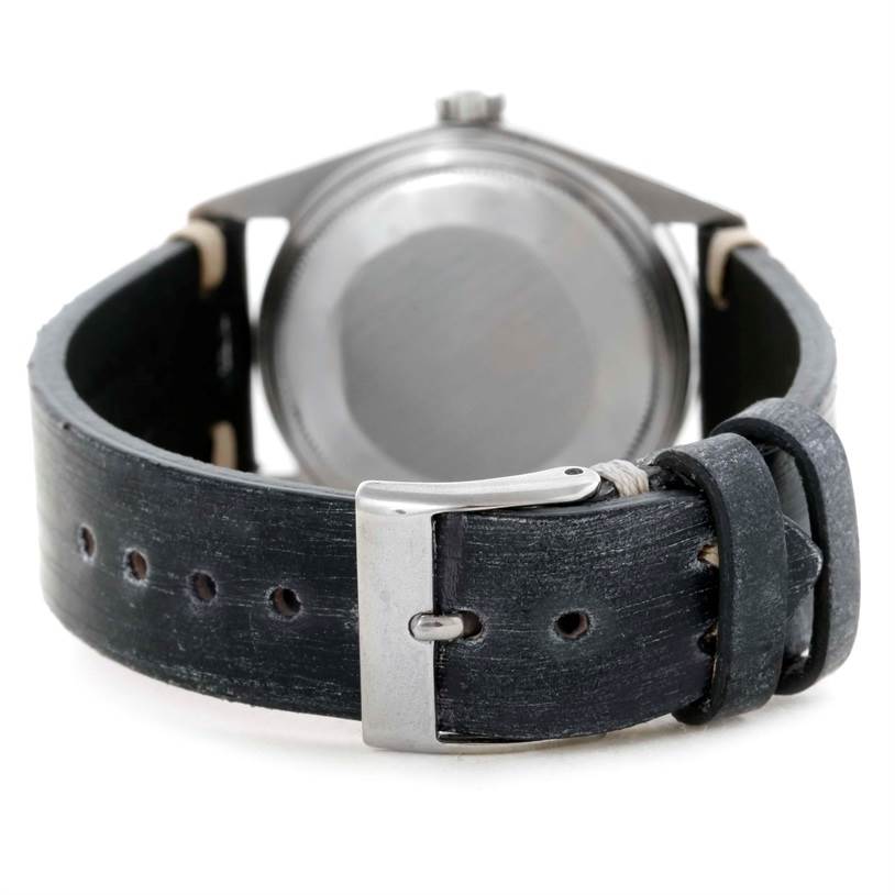 The image shows the back case and leather strap with buckle of a Vintage Collection model by Rolex.