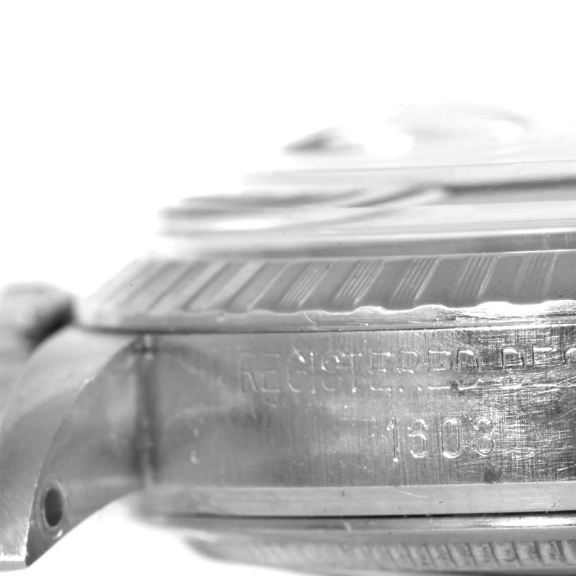 This close-up side angle of the Rolex Vintage Collection 1603 Men's Stainless Steel Silver Dial 1603 Men's Stainless Steel Silver Dial watch shows part of the watch case and the engraved serial number.