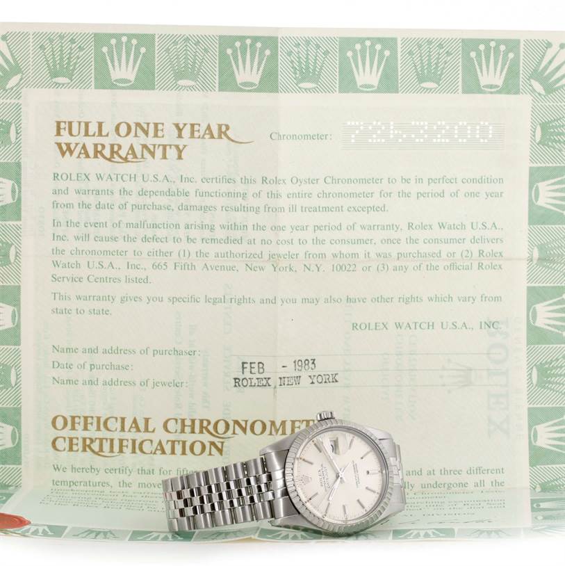 The image shows a Vintage Collection Rolex watch, placed flat on its box, with warranty and certification papers displayed.