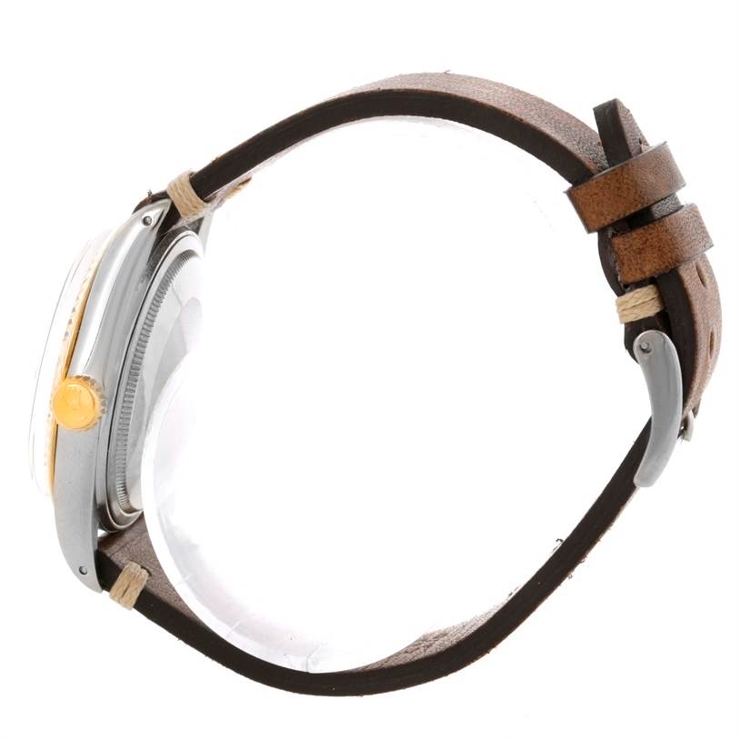 Side angle view of the Rolex Vintage Collection 16013 Men's Stainless Steel Silver Dial 16013 Men's Stainless Steel Silver Dial watch, showing the case, crown, and leather strap.