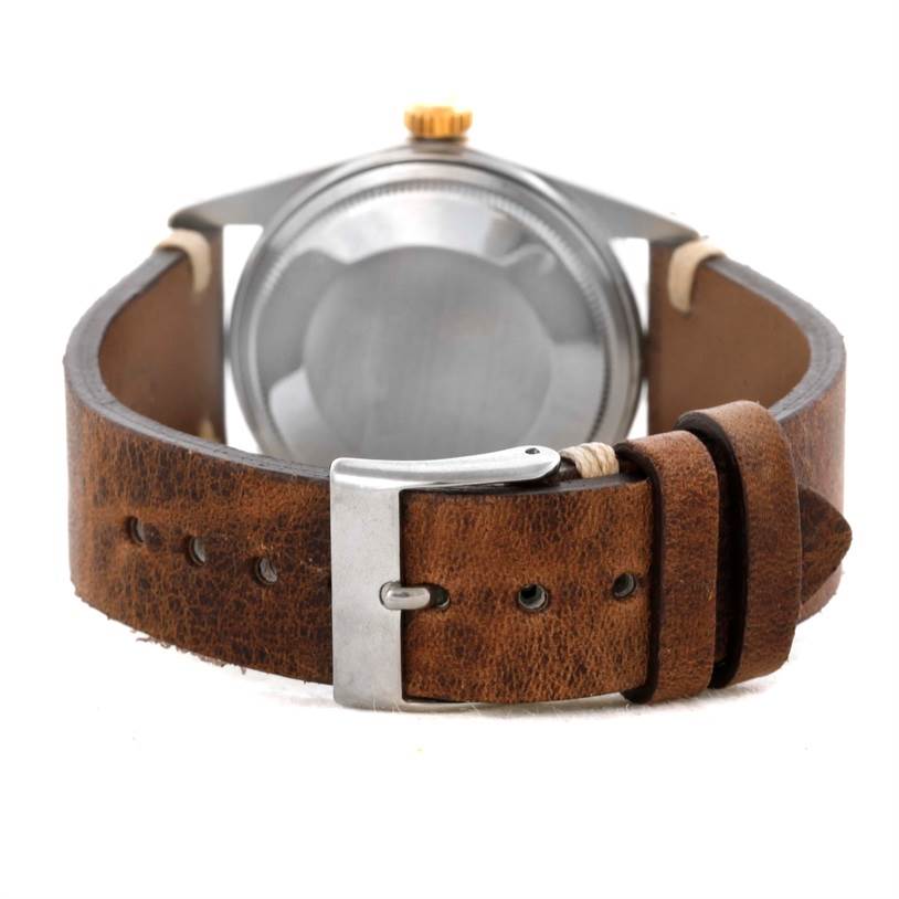 The image shows the back view of a Rolex Vintage Collection 16013 Men's Stainless Steel Silver Dial 16013 Men's Stainless Steel Silver Dial model watch, highlighting its case back and leather strap with buckle.