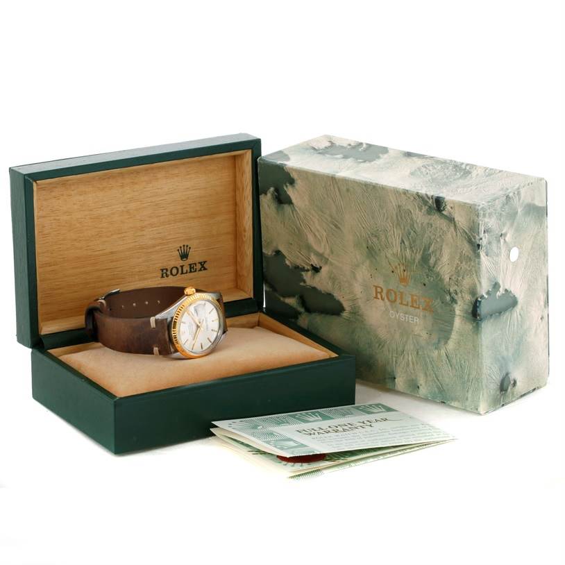 The Vintage Collection Rolex watch is shown at a slight angle within its open box, alongside its outer box and documents.