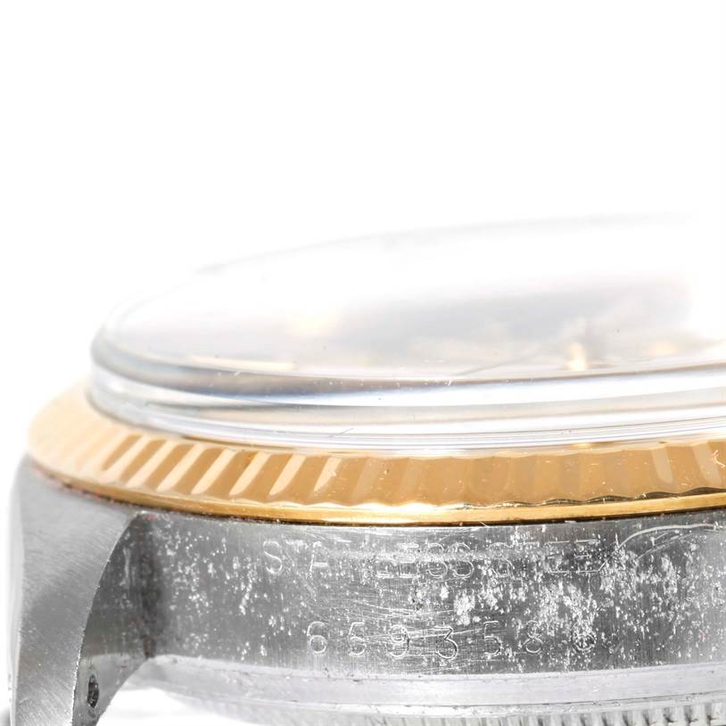 The image shows a close-up, side view of the bezel and case of a Vintage Collection Rolex watch.