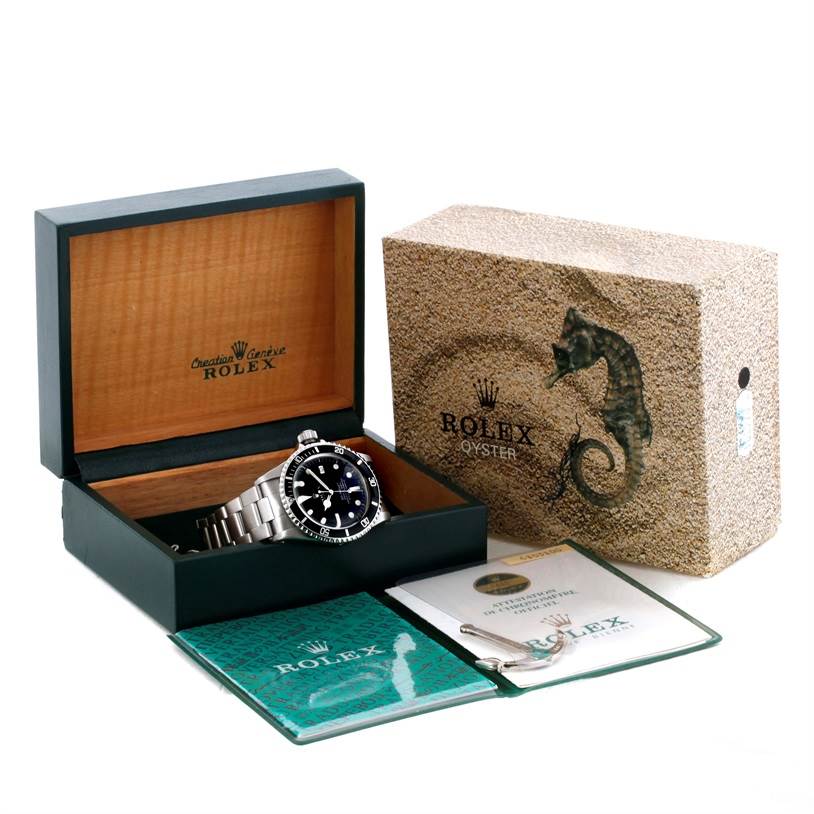 The Rolex Vintage Collection 1665 Men's Stainless Steel Black Dial 1665 Men's Stainless Steel Black Dial watch is displayed in an open box from a slightly angled side view, with warranty cards and original packaging.