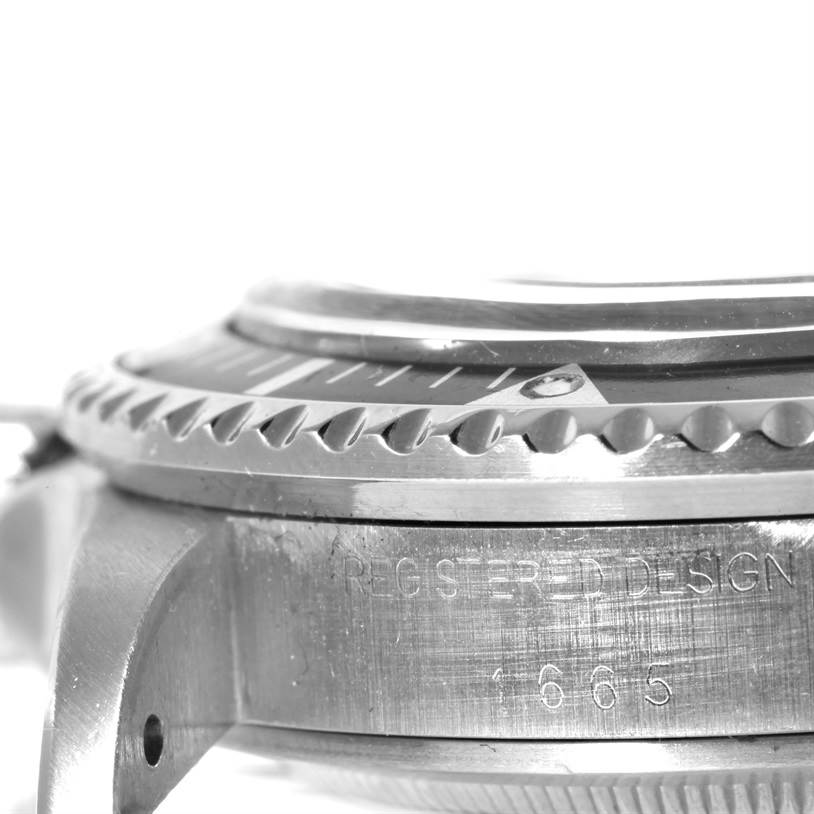 The image shows the side view of the bezel, case, and lug of a Rolex Vintage Collection 1665 Men's Stainless Steel Black Dial 1665 Men's Stainless Steel Black Dial watch.