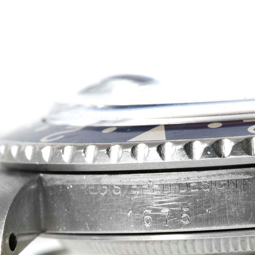 This close-up image of the Rolex Vintage Collection 1675 Men's Stainless Steel Black Dial 1675 Men's Stainless Steel Black Dial model 1675 shows the watch bezel, case side, and part of the crystal.