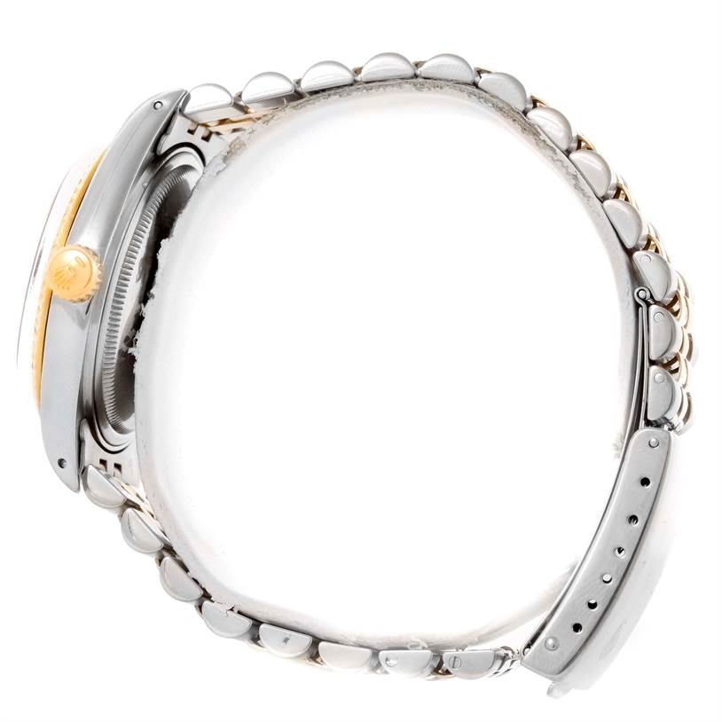 The image shows a side view of the Rolex Vintage Collection 16013 Men's Stainless Steel Champagne Dial 16013 Men's Stainless Steel Champagne Dial watch, displaying its crown, case, and part of the bracelet.