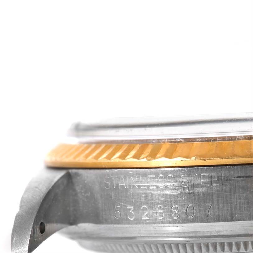 This image shows a close-up side view of the casing and bezel edge of a Vintage Collection Rolex watch.