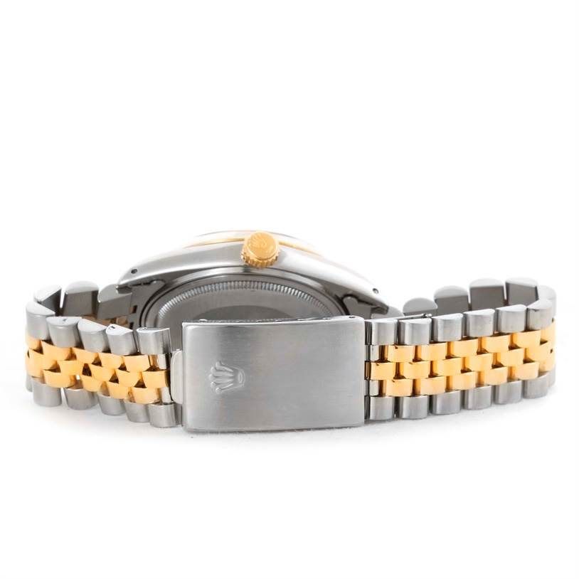 The image shows the back view of a Rolex Vintage Collection 16013 Men's Stainless Steel Champagne Dial 16013 Men's Stainless Steel Champagne Dial watch, highlighting its clasp, caseback, and two-tone bracelet.