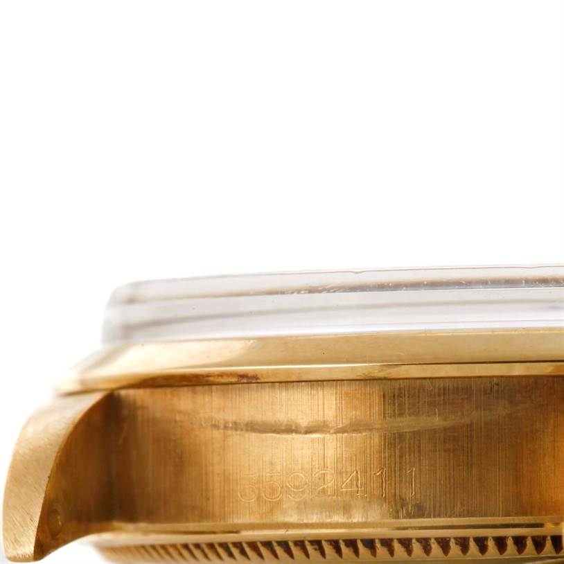 This image shows a close-up side view of the casing, bezel, and part of the crystal of the Rolex Vintage Collection 1002 Men's Yellow Gold Champagne Dial 1002 Men's Yellow Gold Champagne Dial watch.