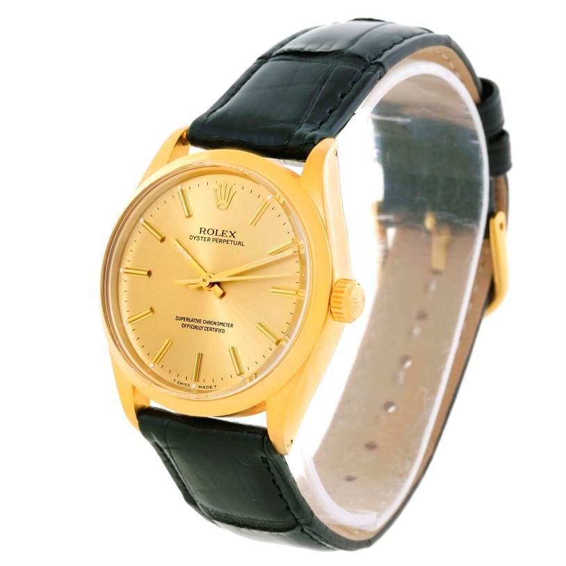The image shows a Rolex Vintage Collection 1002 Men's Yellow Gold Champagne Dial 1002 Men's Yellow Gold Champagne Dial watch at an angled view displaying its gold dial, case, crown, and black leather strap.