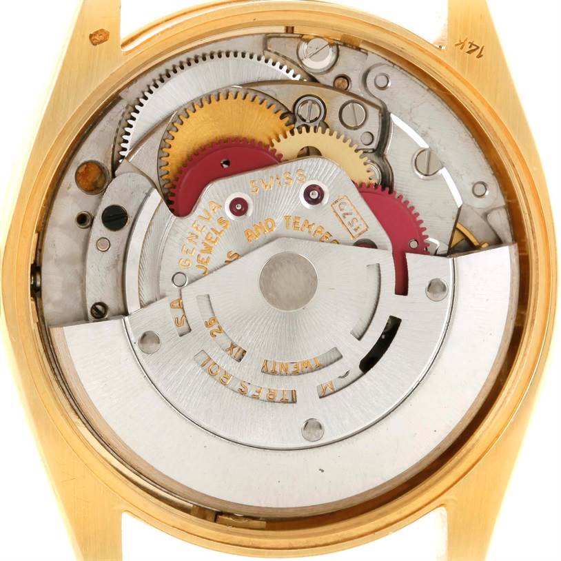 This image shows the internal mechanism of a Vintage Collection Rolex watch from a rear angle, highlighting gears and movement parts.