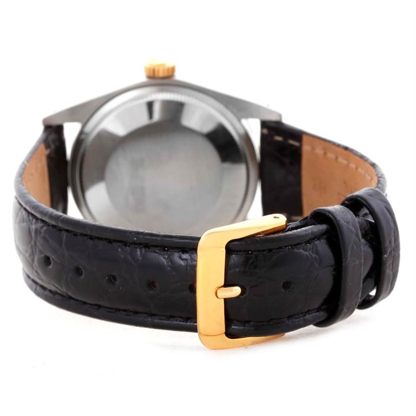 The image shows the backside of a Rolex Vintage Collection 1505 Men's Yellow Gold Champagne Dial 1505 Men's Yellow Gold Champagne Dial watch, highlighting its black leather strap and gold buckle.