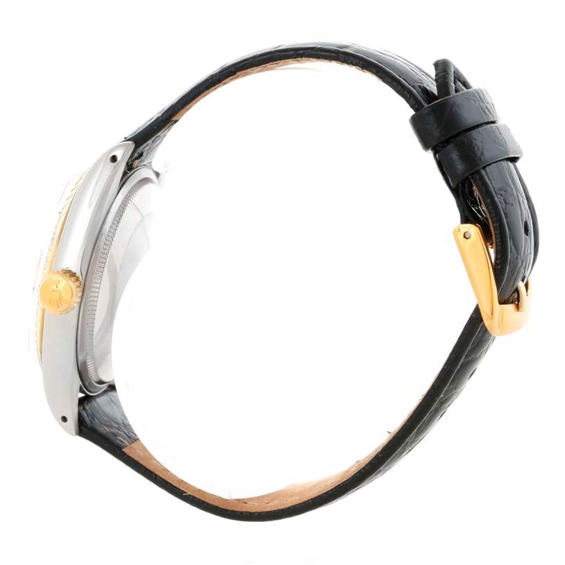 The image shows a side view of a Rolex Vintage Collection 1505 Men's Yellow Gold Champagne Dial 1505 Men's Yellow Gold Champagne Dial watch, highlighting its crown, case, and leather strap.