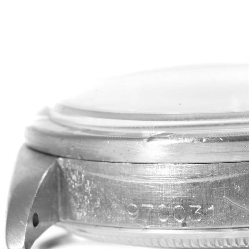 The image shows a close-up side view of the case and bezel of a Vintage Collection model by Rolex, highlighting the serial number.