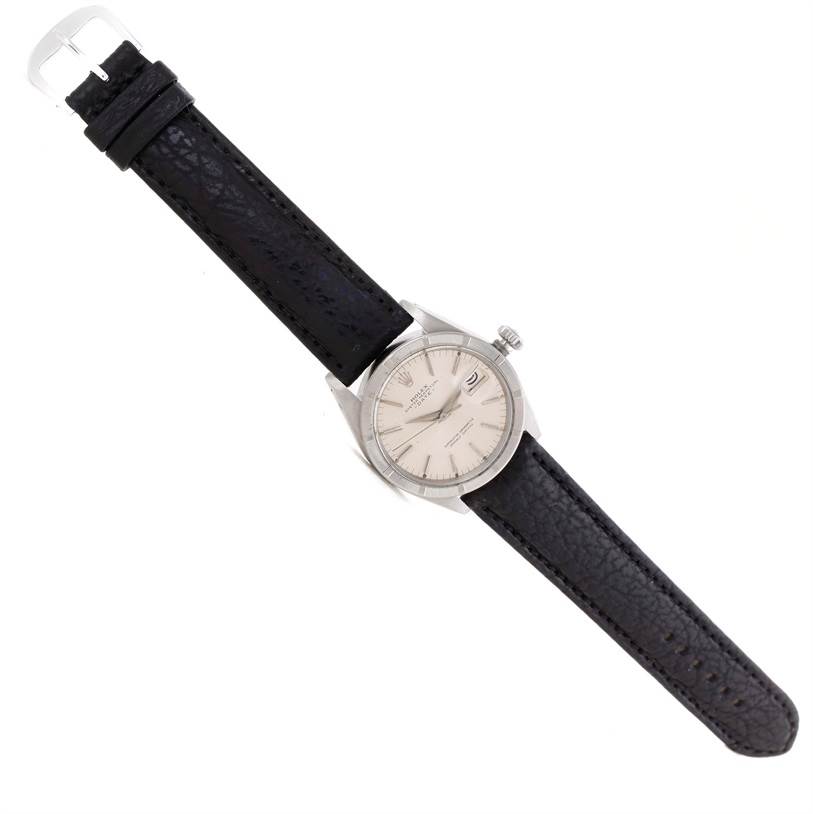 This image shows a top view of the vintage Rolex Collection watch with a black leather strap and a silver round dial.