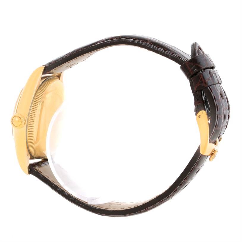 The image shows a side view of a Rolex Vintage Collection 3131G Men's Yellow Gold Silver Dial 3131G Men's Yellow Gold Silver Dial watch, highlighting the gold case and brown leather strap.