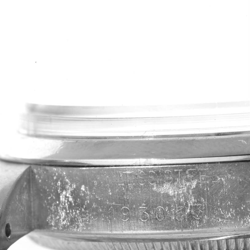 The image shows a close-up of the side of a Rolex Vintage Collection 1500 Men's Stainless Steel Blue Dial 1500 Men's Stainless Steel Blue Dial model watch, focusing on its case with visible engraving.