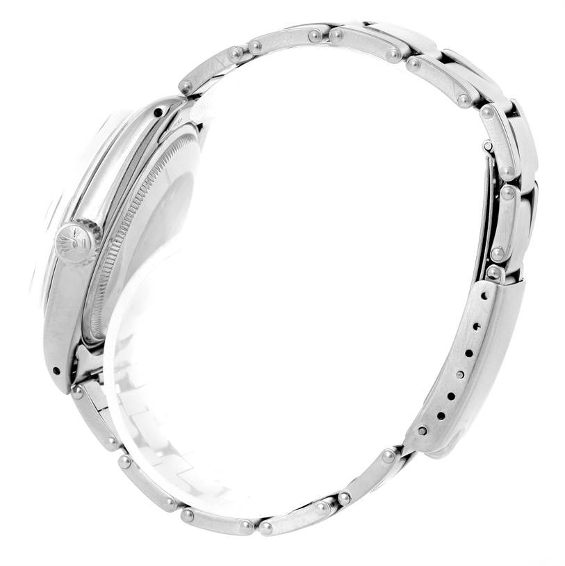 The image shows a Rolex Vintage Collection 1500 Men's Stainless Steel Blue Dial 1500 Men's Stainless Steel Blue Dial watch from the side, focusing on the crown, case, and bracelet.