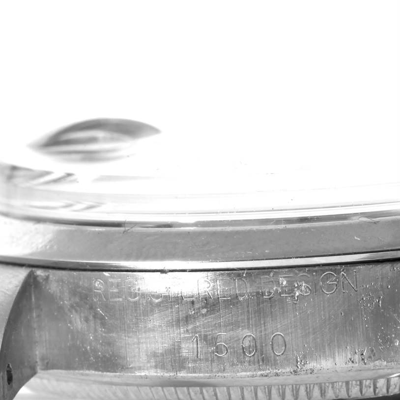 The image shows a close-up of the side case of the Rolex Vintage Collection 1500 Men's Stainless Steel Blue Dial 1500 Men's Stainless Steel Blue Dial model, featuring the serial number and engravings.