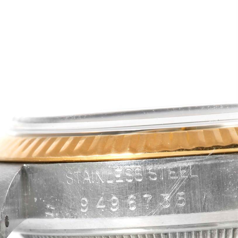 This image shows a close-up side view of a Rolex Vintage Collection 16013 Men's Stainless Steel Champagne Dial 16013 Men's Stainless Steel Champagne Dial watch, focusing on its stainless steel case with visible serial number.